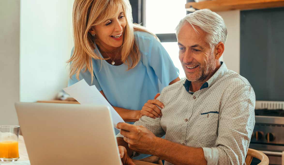 Couple at computer reviewing documents